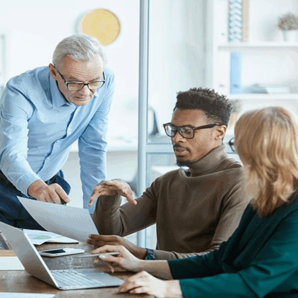 Real estate agents talking and looking at paperwork | Indianapolis commercial asset & lease management