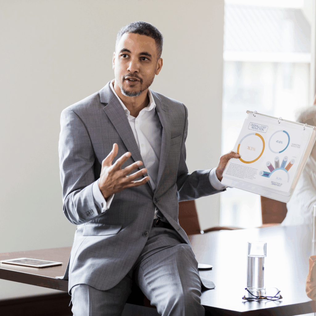 Man presenting paperwork | commercial real estate services in Indianapolis | Indianapolis commercial investment sales and advisory